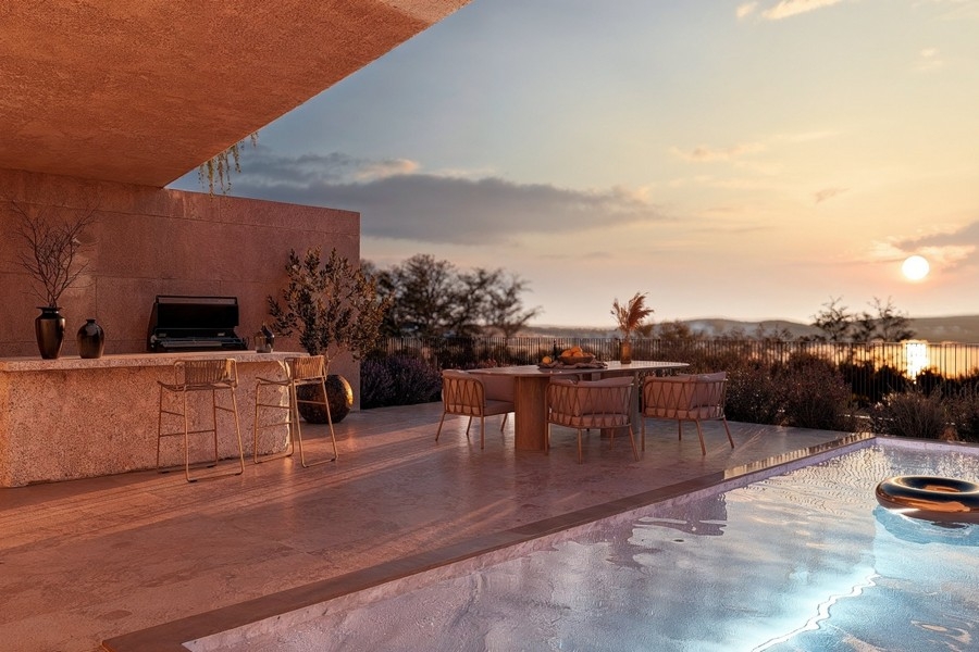 Swimming pool in the evening light overlooking the sea