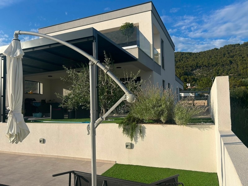 Covered terrace with parasol on the new house on Rab