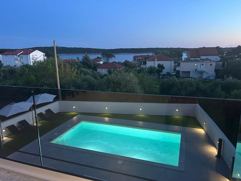 Illuminated pool with views over Banjol and the bay