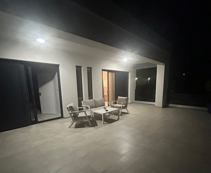Illuminated terrace with seating area in the evening