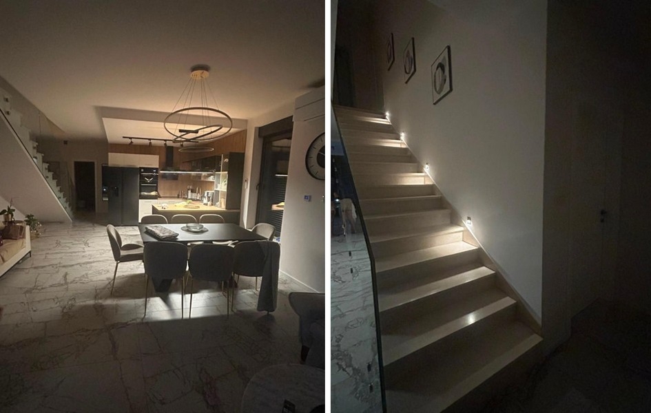 Living area with open kitchen and illuminated staircase