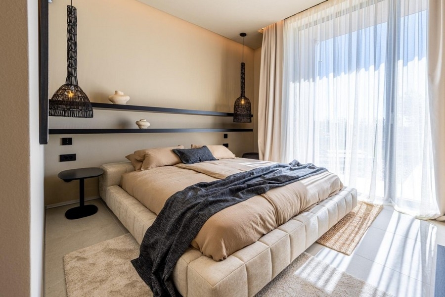 Bedroom with double bed and floor-to-ceiling windows