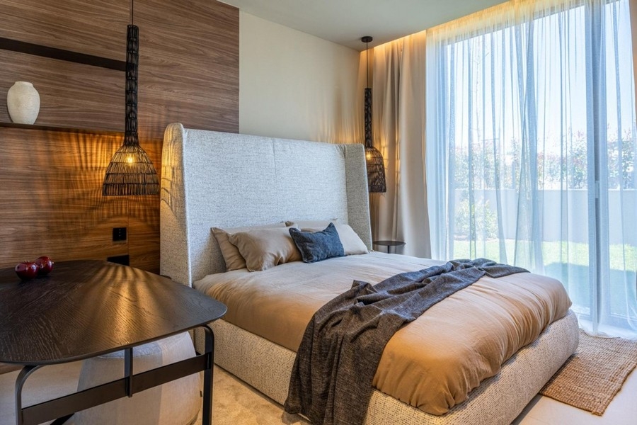Bedroom with upholstered bed and wooden wall in Croatia