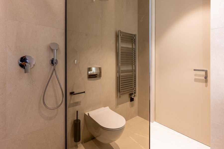 Bathroom with shower, toilet and towel radiator