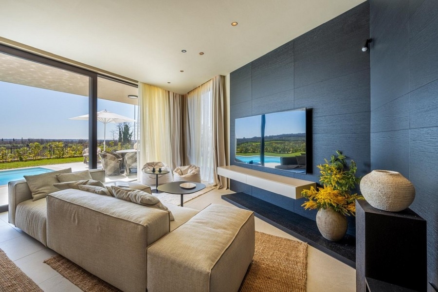 Living area with sofa, TV wall and view of the countryside
