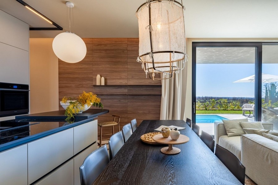 Kitchen with cooking island and view through the glass front
