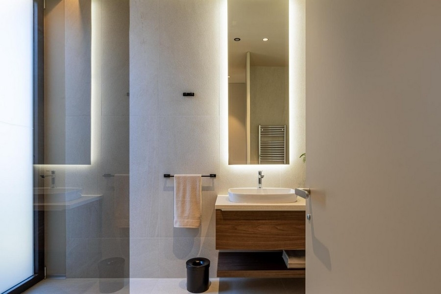 Vanity unit with illuminated mirror in the bathroom