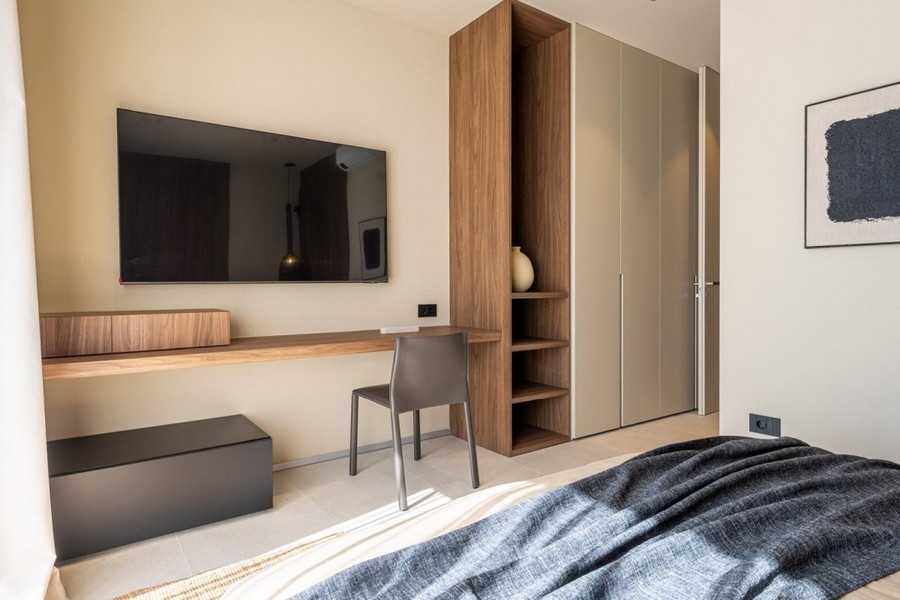 Bedroom with desk, TV and built-in wardrobe