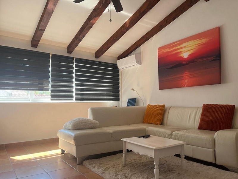 Living room with beamed ceiling and sofa
