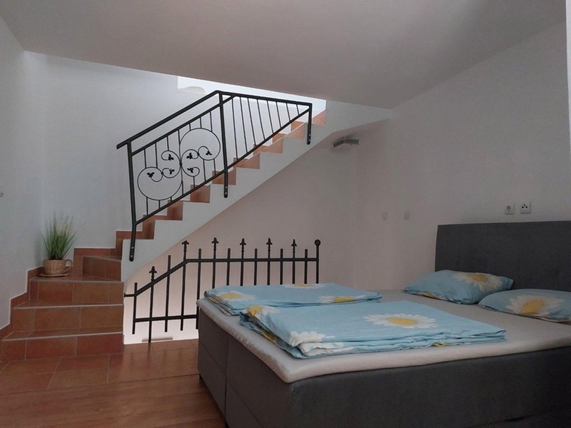 Bedroom with double bed and stairs