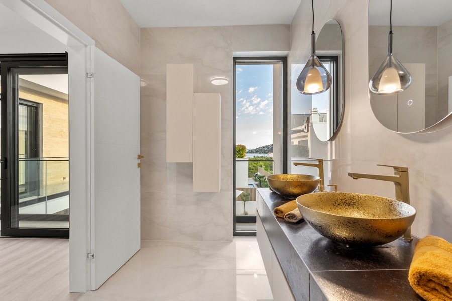Bathroom with two gold sinks