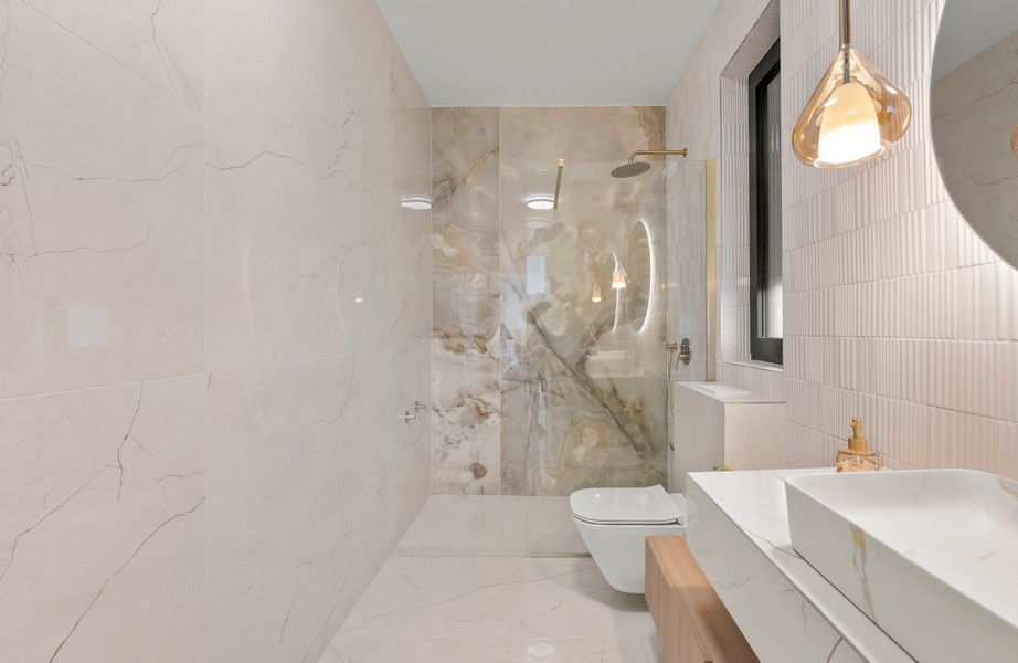 Bathroom with shower and marble tiles