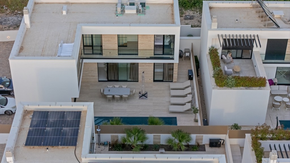 Villa with pool and solar system from a bird's eye view