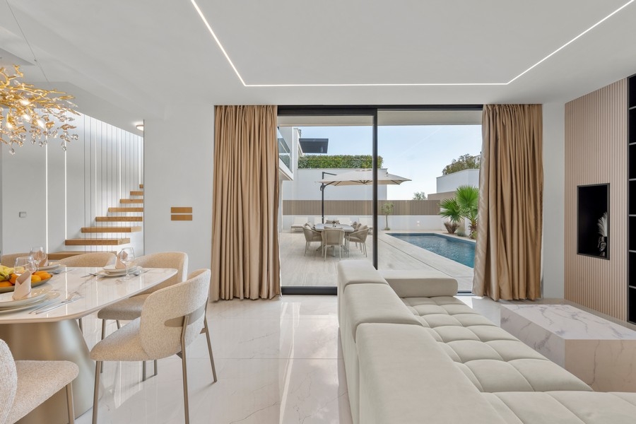 Living room with sofa and access to the pool terrace