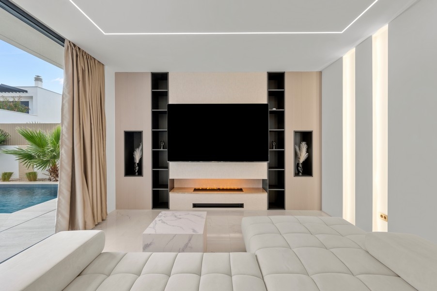 Living room with TV wall and built-in shelves
