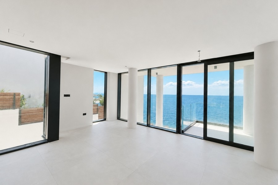 Room with glass front and terrace with sea views