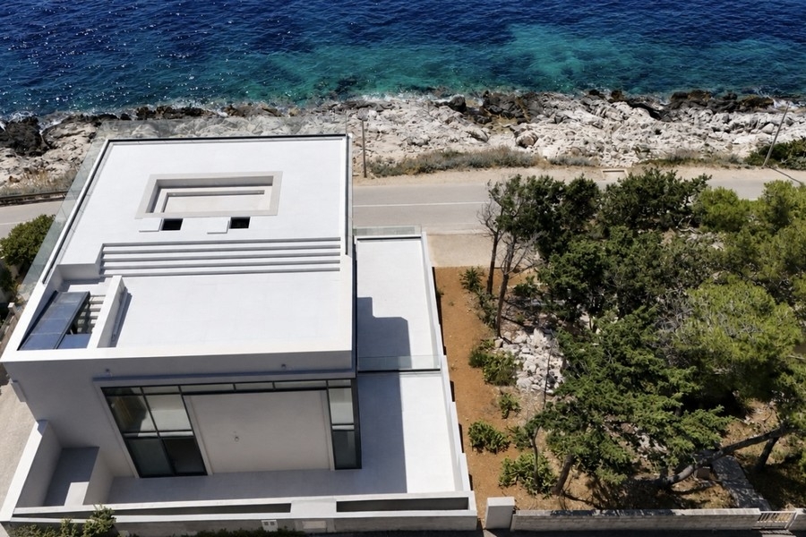 Villa from above with coastal road and sea