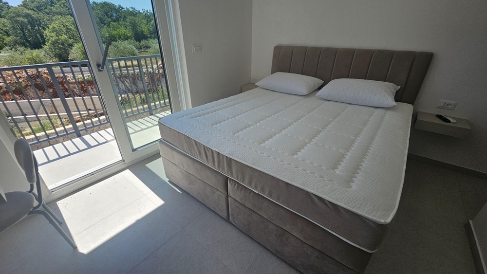 Bedroom with double bed and balcony door