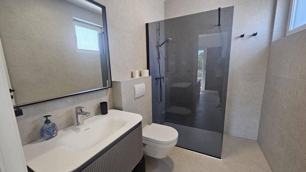 Bathroom with shower and vanity