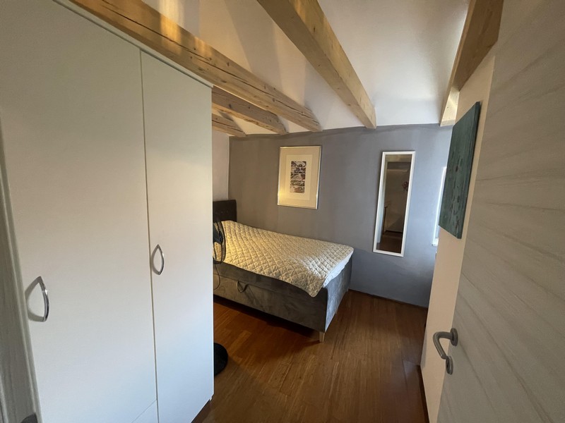 Bedroom with wardrobe and double bed in the attic