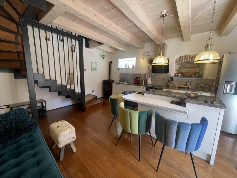 Open living area with kitchen and beamed ceiling