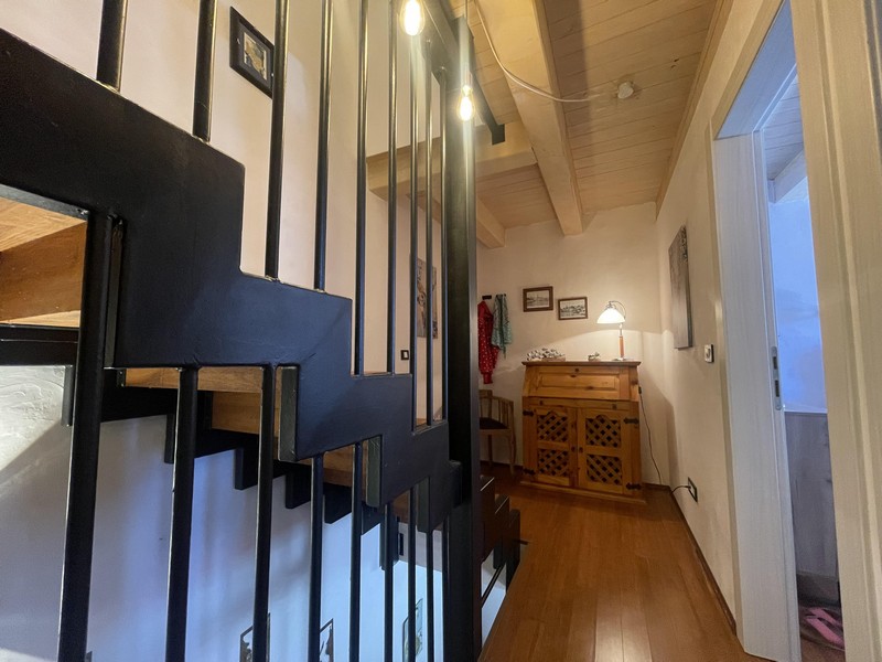Staircase with metal railings and hallway on the upper floor