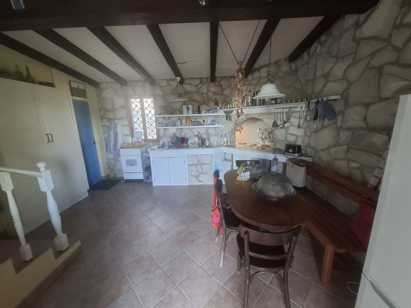 Kitchen with dining area and natural stone wall in the house on Solta