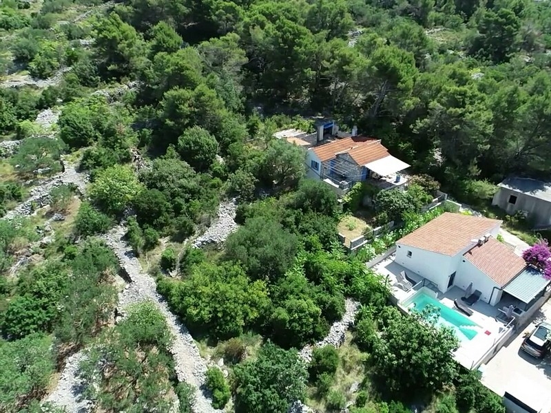 Aerial view of the house in green surroundings near the sea