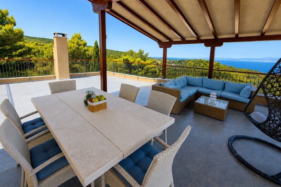Covered roof terrace with seating area and sea views of Brac