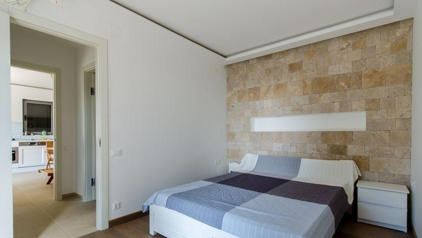Bedroom with natural stone wall and double bed