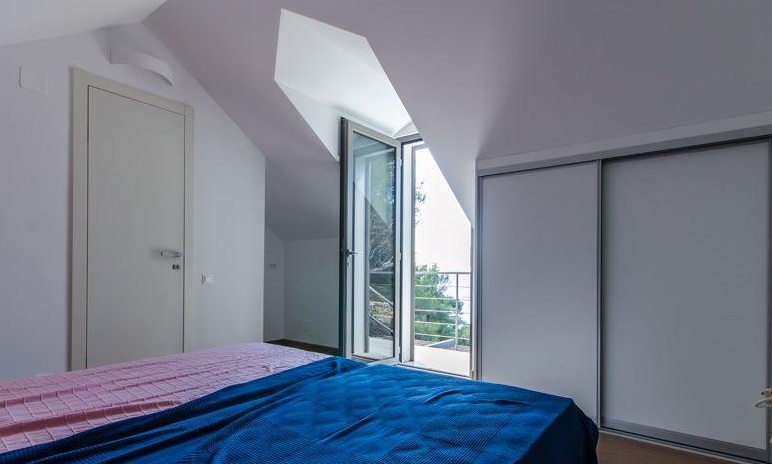 Bedroom in the attic with balcony door