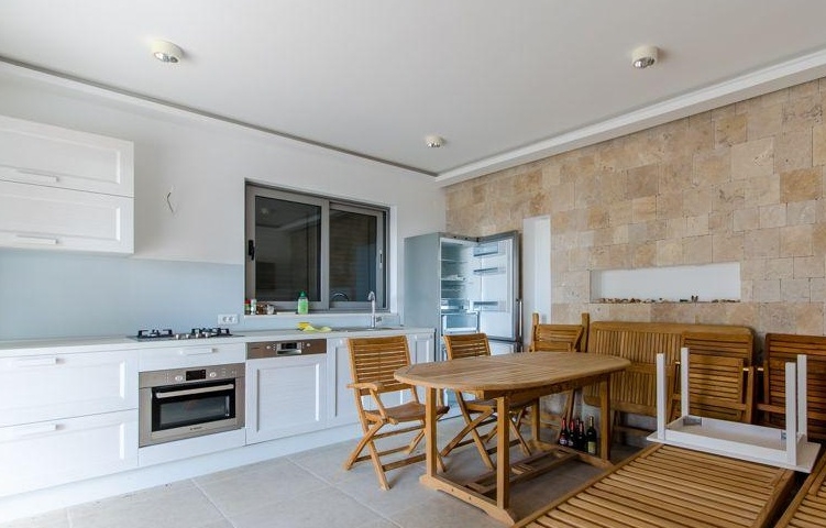 Kitchen with dining area and natural stone wall