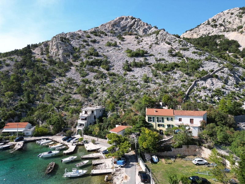 Bay with clear water and the Velebit mountains from above