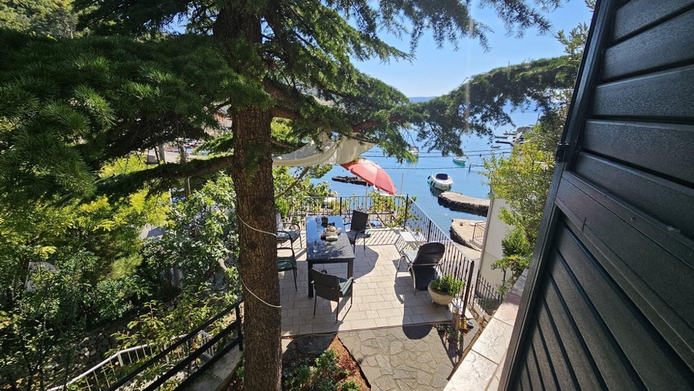 Seating under the trees with a sea view