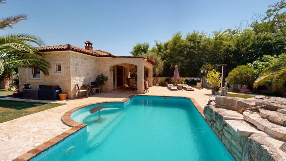 Swimming pool with sun terrace and view of the house