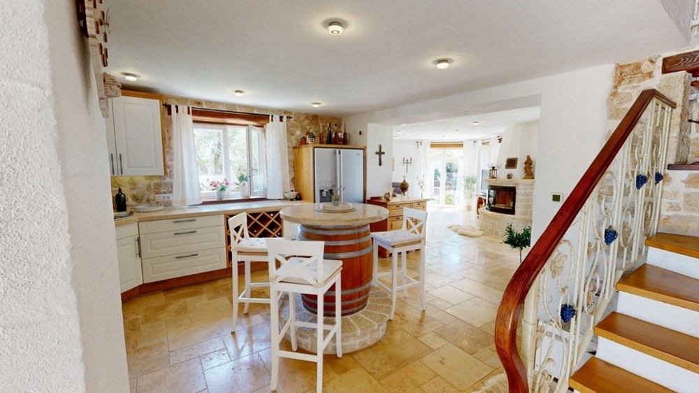 Kitchen with cooking island and stairs to the upper floor
