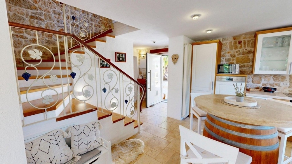 Staircase with wrought iron railing and dining area