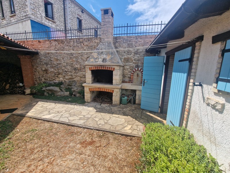 Inner courtyard with barbecue area and stone facade