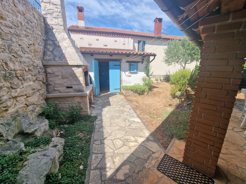 Access to the house with blue shutters