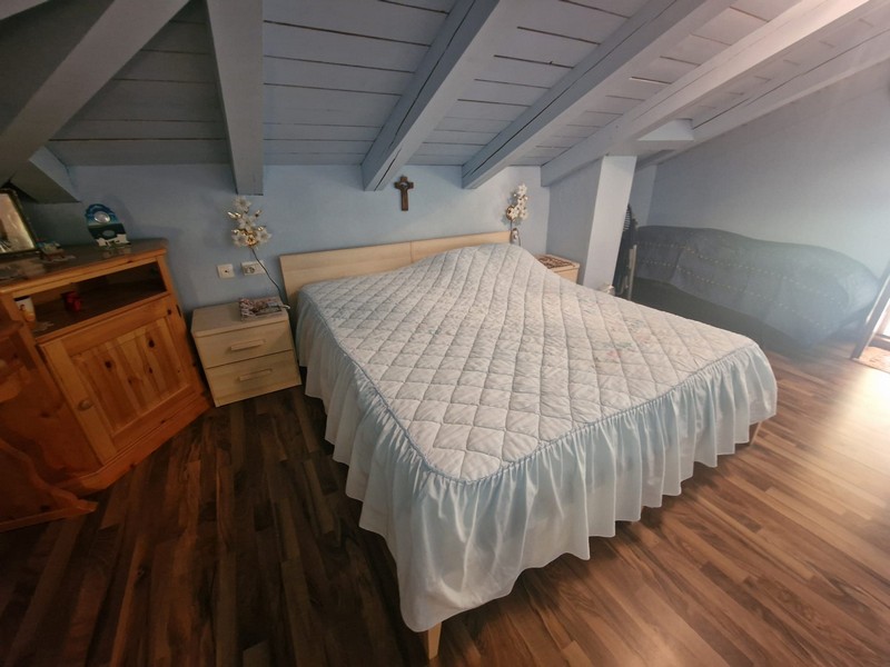 Bedroom with double bed and wooden floor
