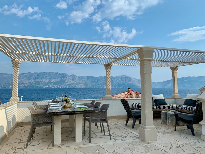Covered terrace with seating area and sea view, house H4090 Povlja