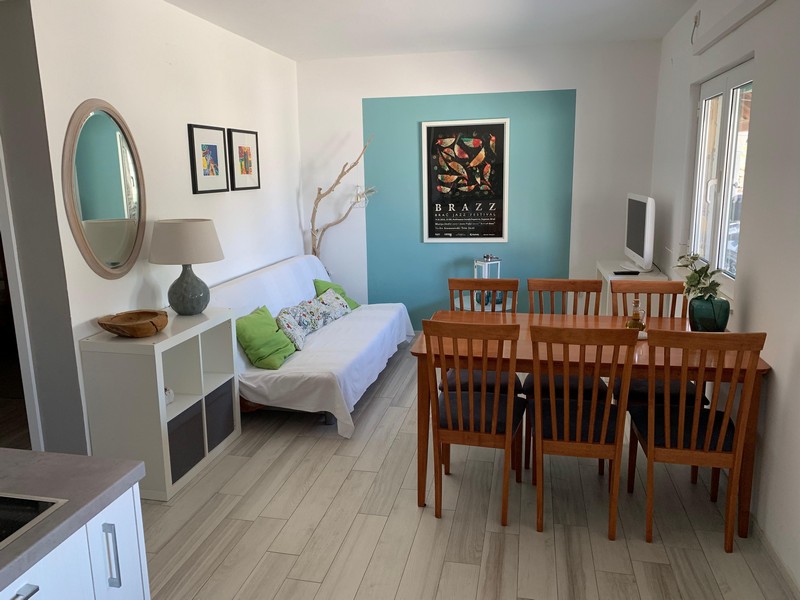 Living area with dining area in one of the apartments, house H4090 Povlja