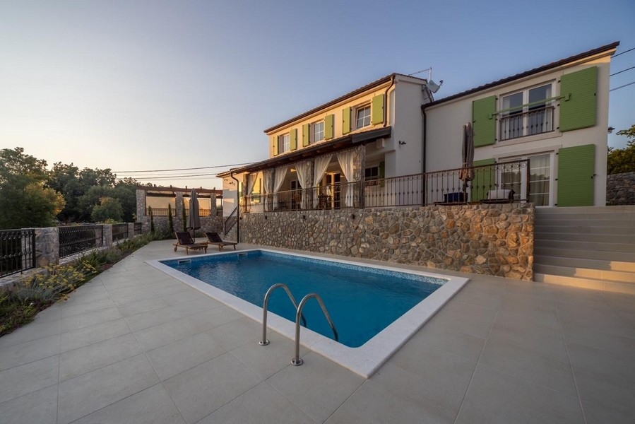 Swimming pool in front of the stone house on the island of Krk