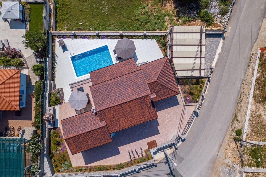 Aerial view of house with pool and grounds