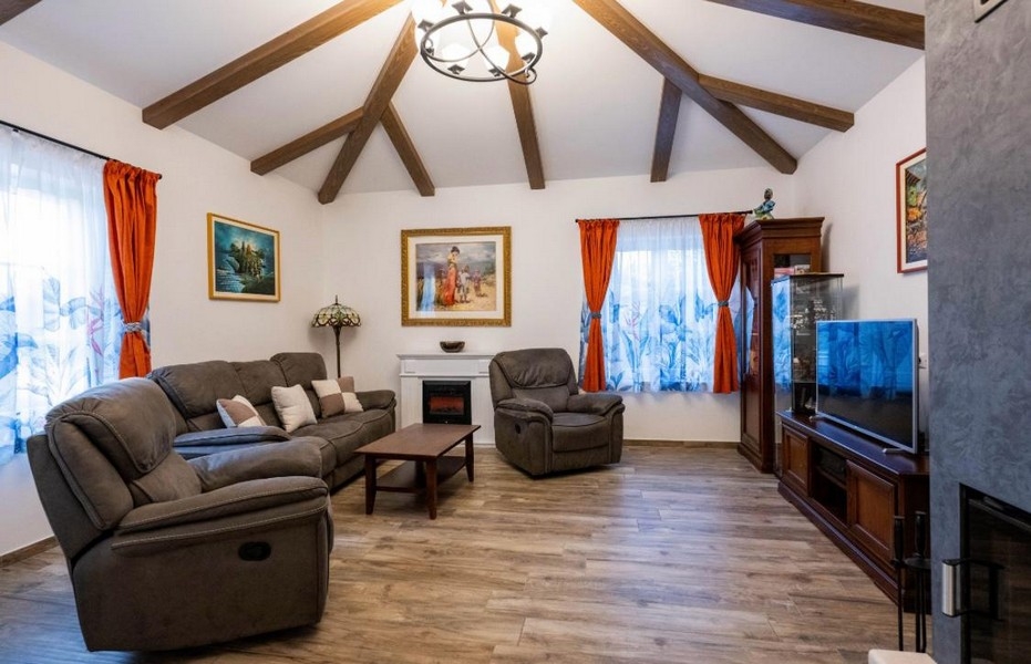 Living area with wooden ceiling and fireplace