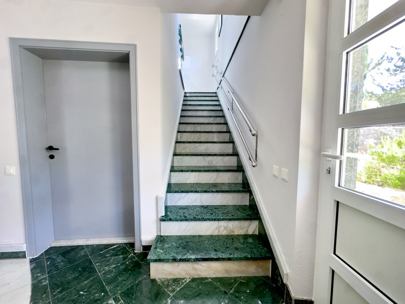 Stairs to the upper floor of the villa