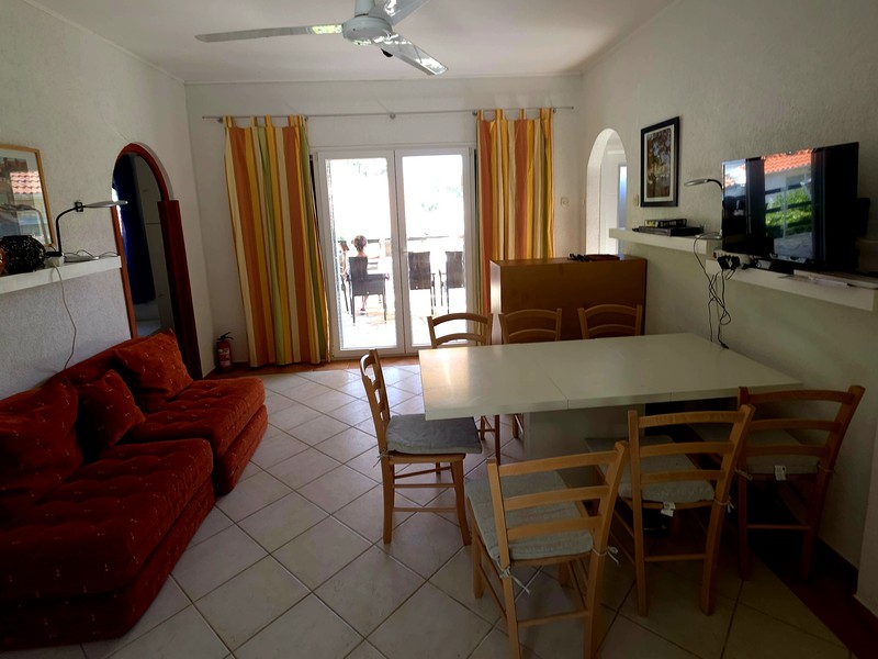 Living and dining area with dining table and door to the terrace