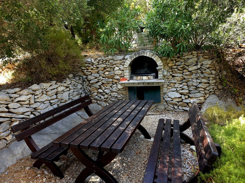 Barbecue area with brick outdoor fireplace in the garden