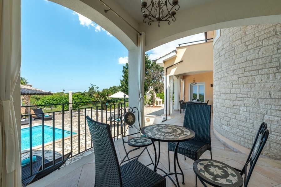 Covered terrace with seating by the pool of the villa near Porec