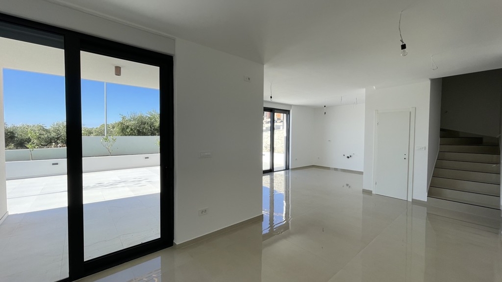 Living room with patio door and stairs to the upper floor in Vodice